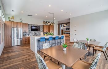 Resident lounge with kitchen, dining space and fireplace